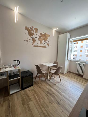 a room with a table and chairs and a map on the wall at Raffaelli Suite in Rome