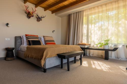 a bedroom with a large bed and a window at The Pines Bucegi Lodge in Bran