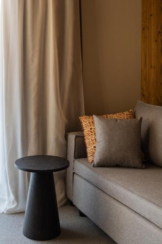 a living room with a couch and a table at The Pines Bucegi Lodge in Bran