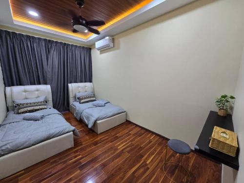 a living room with two beds and a couch at Qaira Eco Homestay in Kota Kinabalu