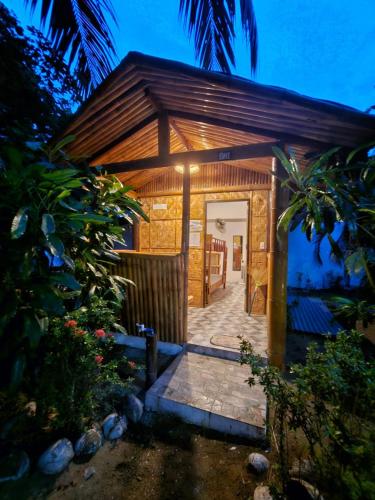 a small building with a pathway leading to the door at Big BamBoo Beach Resort Sipalay in Sipalay