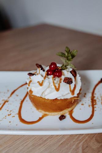 a dessert on a white plate on a table at Hôtel De France in Chalabre