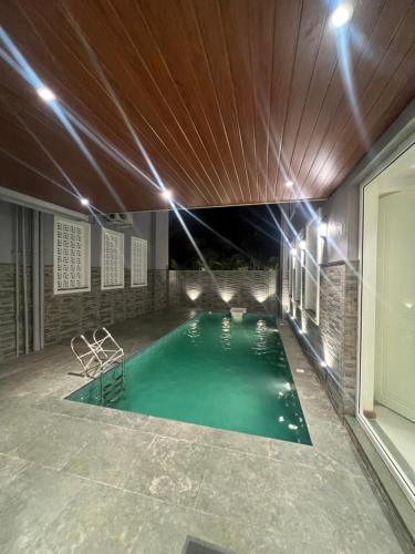 a swimming pool in a house with lights at VILLA M- SAVANNAH 7- 5BHK Brand New Villa in Calangute with Private Pool, Near Beach, free Breakfast, north goa in Goa