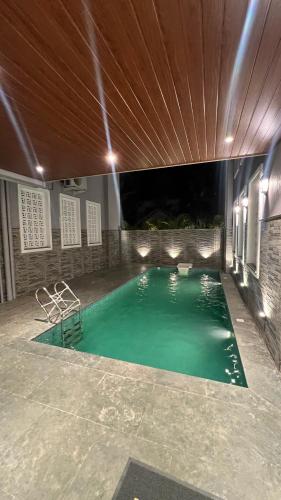 a swimming pool in the middle of a building at VILLA M- SAVANNAH 7- 5BHK Brand New Villa in Calangute with Private Pool, Near Beach, free Breakfast, north goa in Goa