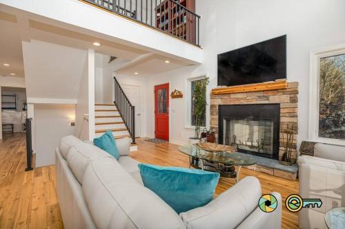 a living room with a white couch and a fireplace at The Swirling Bird in Basye