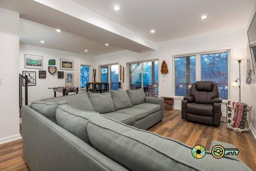 a living room with a gray couch and a chair at The Swirling Bird in Basye