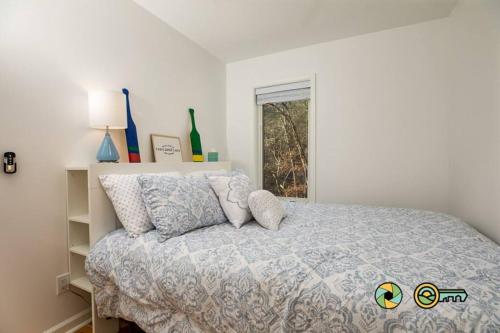 a bedroom with a bed with pillows and a window at The Swirling Bird in Basye