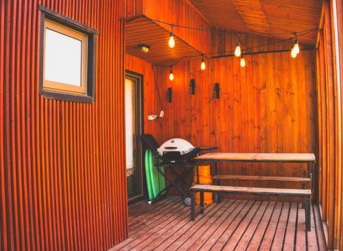 a room with a wooden wall with a bench in it at Casa 46 en condominio Piscina Climatizada in Pichilemu