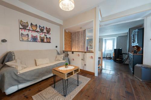 a living room with a bed and a table at Gite La Pondique in Escot