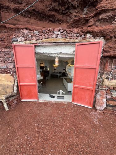 an open door into a room in a rock wall at Casa Rural Cueva Las Varas in El Mudo