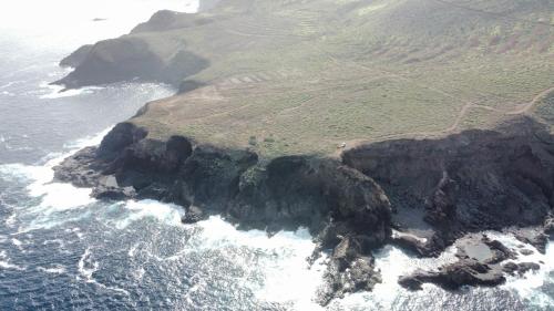 an aerial view of a rocky island in the ocean at Casa Rural Cueva Las Varas in El Mudo