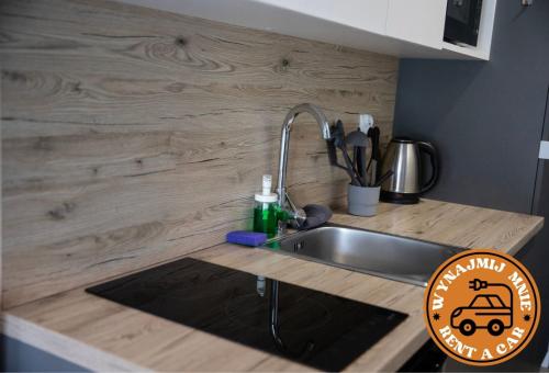 a kitchen counter top with a sink and a sink at ADLER Room Suite in Łódź
