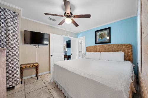 a bedroom with a bed and a ceiling fan at Surfs Up in Gulf Shores