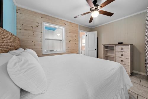 a bedroom with a white bed and a window at Surfs Up in Gulf Shores