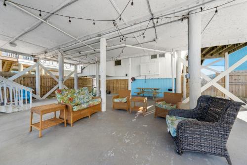 a living room with couches and chairs and a table at Surfs Up in Gulf Shores