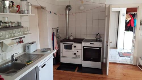 a kitchen with a sink and a stove at Ferienhaus Mesnerhaus Steuerberg in Feldkirchen in Kärnten