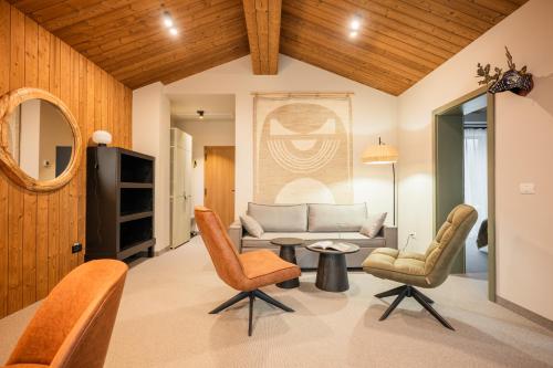 a living room with a couch and chairs at The Pines Bucegi Lodge in Bran