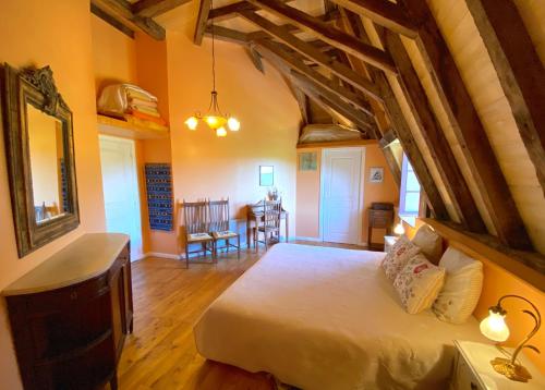 a bedroom with a large bed in a room with wooden floors at Le Chateau de Busqueilles La Suite in Autoire