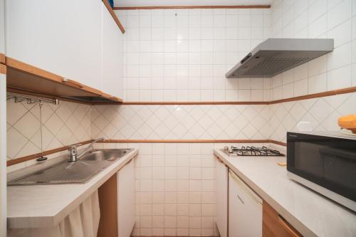 a kitchen with a sink and a stove at Trevi Fountain by BuddyRent in Rome
