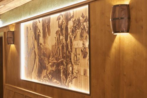 a painting hanging on a wall in a room at Wellness- und Bierhotel Adam Bräu in Bodenmais