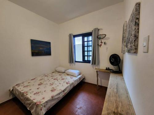 a bedroom with a bed and a window at casa família in Rio de Janeiro