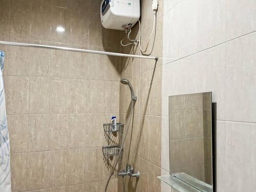 a shower with a shower head and a mirror at Large Villa 3BR Cieumbuleuit near PVJ & Cihamplas by 2ndHome in Bandung