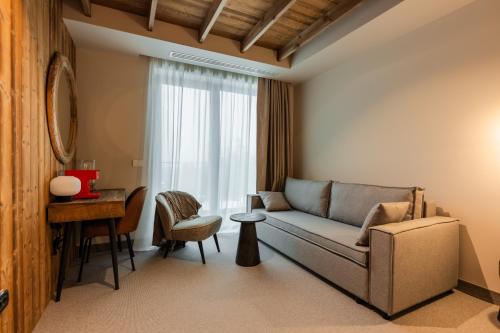 a living room with a couch and a table at The Pines Bucegi Lodge in Bran