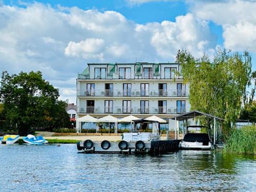 a large building sitting on top of a body of water at Relax place & restaurant in Zegrze Południowe