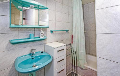 a bathroom with a blue sink and a shower at Ferienwohnung Graal-Müritz in Graal