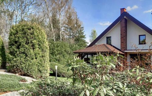 a house with a garden in front of it at 2 Bedroom Awesome Home In Gorzkie Pole in Wronczyn
