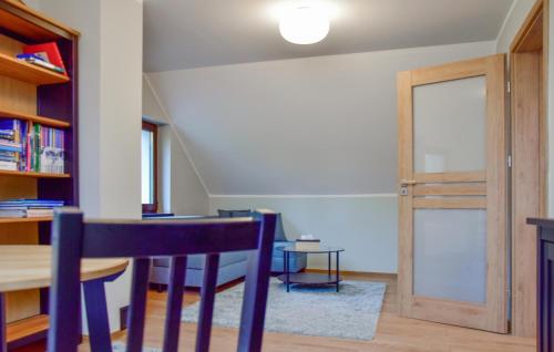 a dining room with a table and a door at 2 Bedroom Awesome Home In Gorzkie Pole in Wronczyn