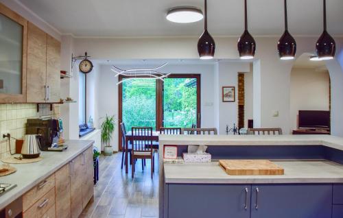 a kitchen with a counter and a dining room at 2 Bedroom Awesome Home In Gorzkie Pole in Wronczyn