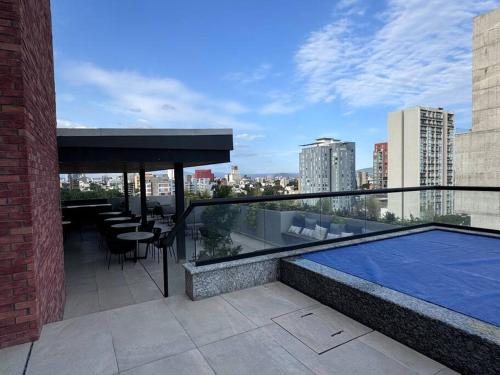 a balcony with a swimming pool on top of a building at Loft Sant Marteen - Americana in Guadalajara