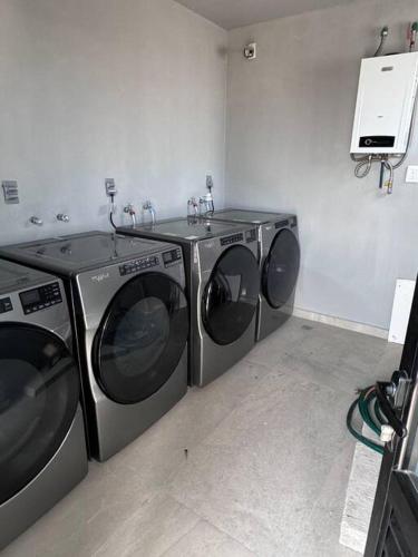 two washing machines sitting next to each other in a room at Loft Sant Marteen - Americana in Guadalajara