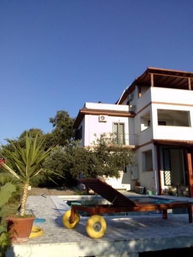 a view of a house with a surfboard and a table at Country House with Pool in Nerola in Nerola