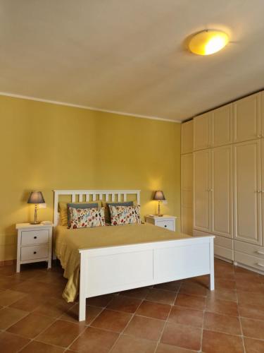 a bedroom with a large bed and two night stands at Country House with Pool in Nerola in Nerola