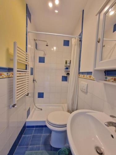 a bathroom with a toilet and a tub and a sink at Country House with Pool in Nerola in Nerola