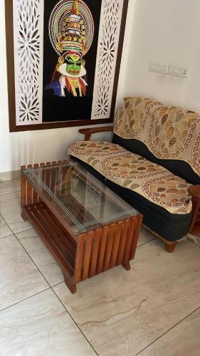 a living room with a couch and a coffee table at Nilaavu Homes - The Staycation at Wayanad in Panamaram