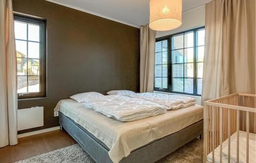 a bed in a bedroom with a large window at Gorgeous Home In Idre With Sauna in Idre