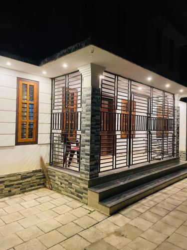 a house with wooden windows at Nilaavu Homes - The Staycation at Wayanad in Panamaram
