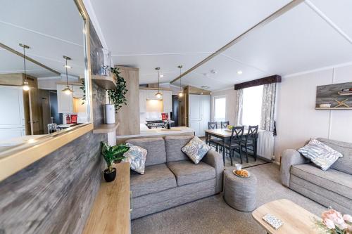 a living room with a couch and a table at 2Bed Whitley Bay Home - Free Parking, Close to beach & St Mary's Lighthouse in Whitley Bay