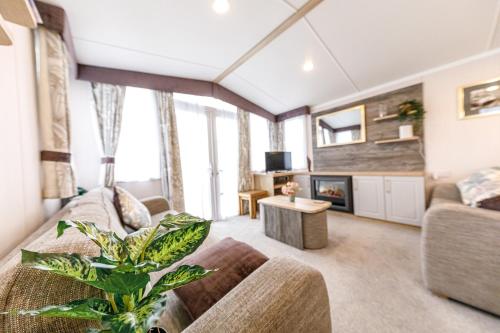 a living room with a couch and a table at 2Bed Whitley Bay Home - Free Parking, Close to beach & St Mary's Lighthouse in Whitley Bay