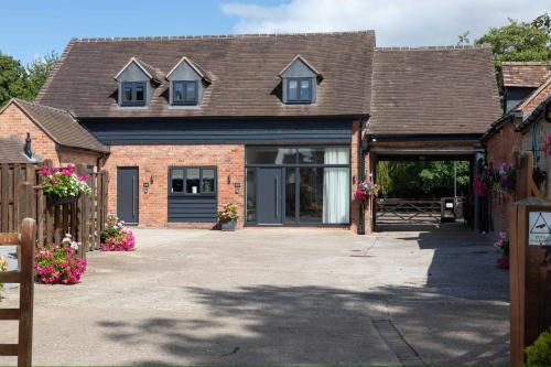 a brick house with a garage and a driveway at The Lawley in Shrewsbury