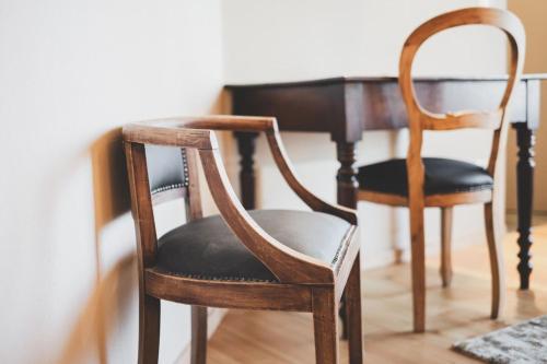 two wooden chairs sitting next to a table at La Caso Di Elva in Elva