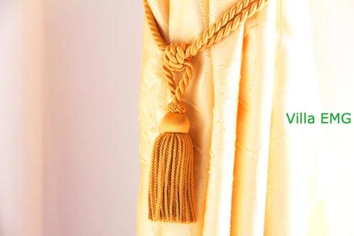 a curtain with a crocheted rope hanging from a window at Haus EMG Hockenheim in Hockenheim