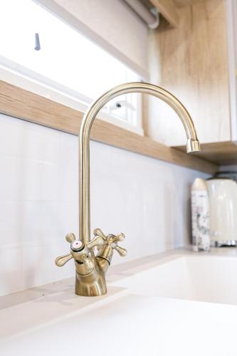 a kitchen sink with a faucet on a counter at 2Bed Whitley Bay Home - Free Parking, Close to beach & St Mary's Lighthouse in Whitley Bay