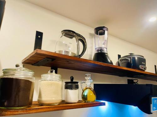 a shelf with jars and other items on it at Serenity Glampings Quinta Montaña in Cóbano