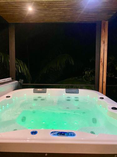 a jacuzzi bath tub with a view at Serenity Glampings Quinta Montaña in Cóbano