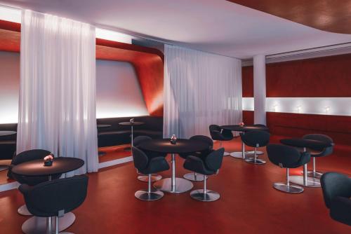 a waiting room with black chairs and tables at Hotel Q! Berlin in Berlin