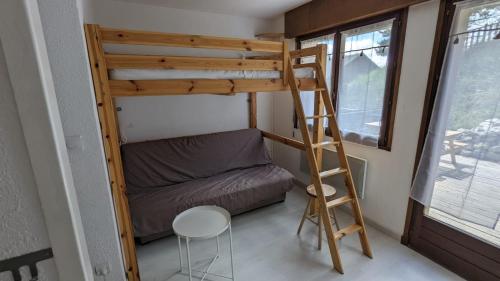 a bunk bed in a tiny room with a ladder at Studio avec terrasse à Valberg, Le St Honorât in Valberg